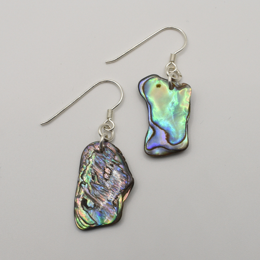 The Earrings | Paua Shell Ruru by Salty Dreamers feature handmade dangle earrings with silver hooks and unique, iridescent paua shell pendants—perfect for lovers of natural beauty. Shown on a plain white background.