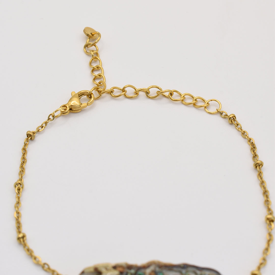 Close-up of the Salty Dreamers Bracelet | Paua Shell Takaro, featuring a delicate gold chain with adjustable clasp and a glimpse of its beautiful pāua shell pendant—an elegant piece of handmade New Zealand jewelry.