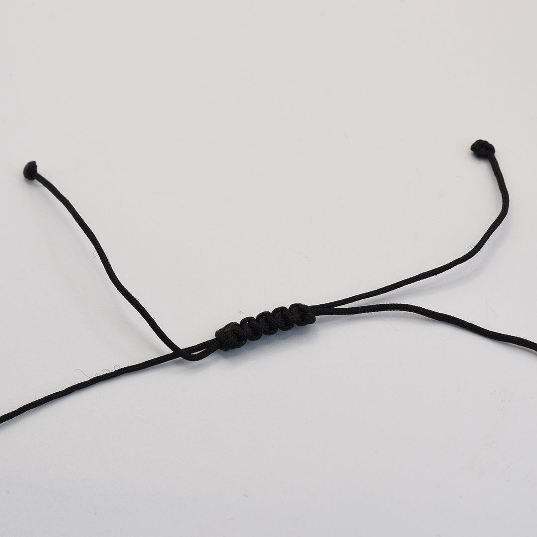 The Paua Shell Whitau Necklace by Salty Dreamers features a black waterproof nylon cord with a sliding adjustable knot, shown on a plain white background—ideal for fans of ocean-inspired jewelry.