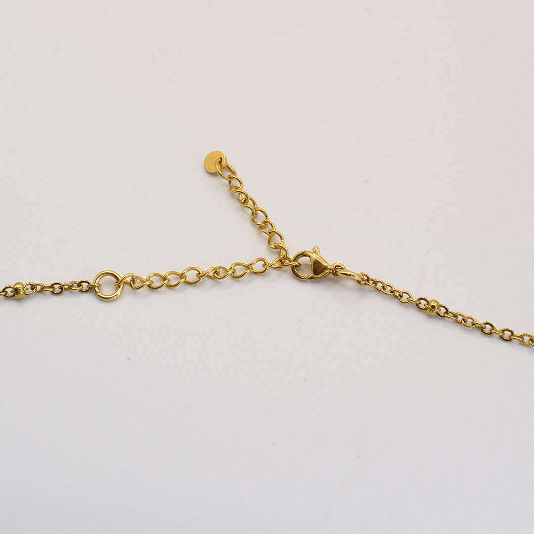 A close-up of the Salty Dreamers Paua Shell Moana necklace with a gold chain, adjustable extension, and lobster clasp—handmade in the spirit of New Zealand jewelry, shown on a plain white background.