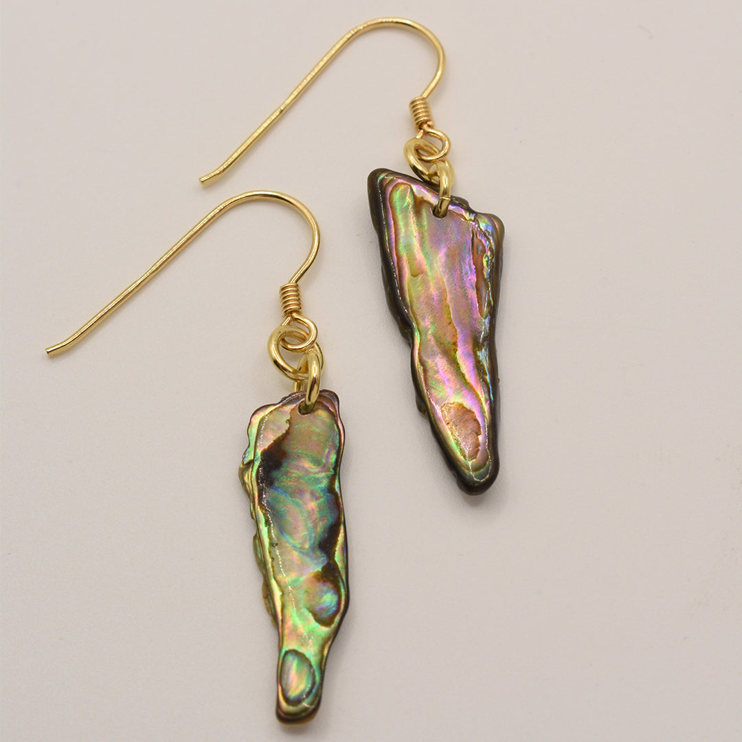 Salty Dreamers Earrings | Paua Shell Mahaki feature irregular, iridescent New Zealand abalone shell pendants with gold-plated silver hooks, beautifully displayed on a light background.