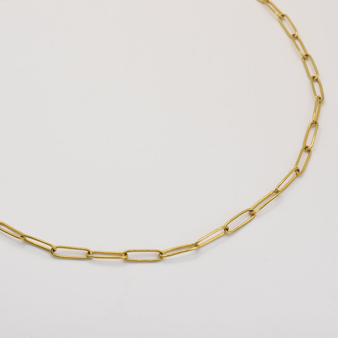 The Necklace | Golden Vibes by Salty Dreamers is a handmade thin gold chain with elongated oval links, showcased on a plain white background.