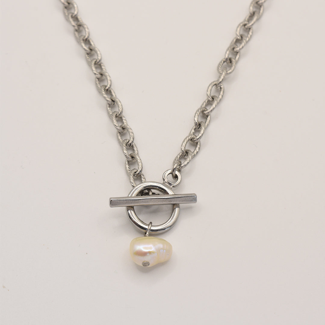 The Cutie Pearl Necklace by Salty Dreamers features a silver chain with a toggle clasp and an irregular freshwater pearl pendant, shown on a plain light background.