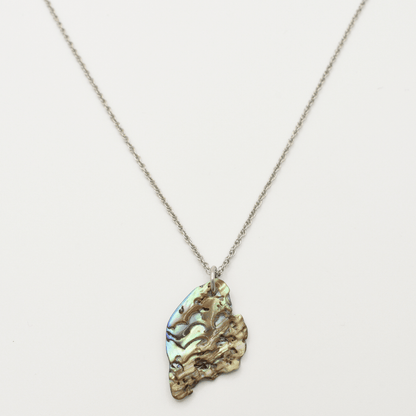 The Necklace | Paua Shell Mahaki by Salty Dreamers features a silver chain with a textured, iridescent pāua shell pendant in green, blue, and gold tones, presented on a white background.