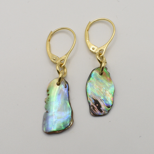 Salty Dreamers Earrings | Paua Shell Kaha: Handmade, irregular pāua shell pendants on gold lever-back hooks, displaying New Zealand abalone’s iridescent green, blue, and purple hues.