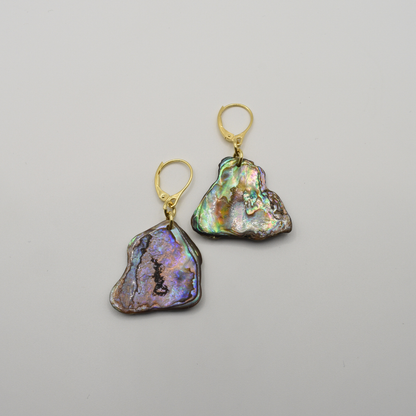 Salty Dreamers' Paua Shell Honu earrings feature handmade gold lever-backs with irregular iridescent New Zealand abalone pendants, shown on a plain white background.