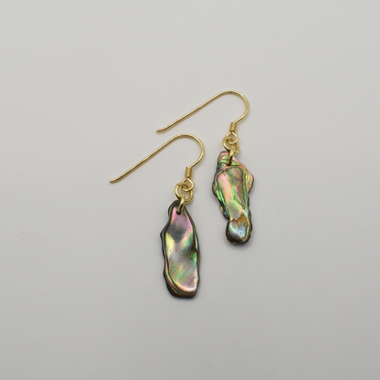 Salty Dreamers' Earrings | Paua Shell Rangi are gold-plated silver hook earrings with irregular iridescent pāua shell pendants in green, pink, and blue hues, shown on a plain white background.
