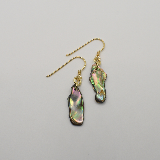 Salty Dreamers' Earrings | Paua Shell Rangi are gold-plated silver hook earrings with irregular iridescent pāua shell pendants in green, pink, and blue hues, shown on a plain white background.