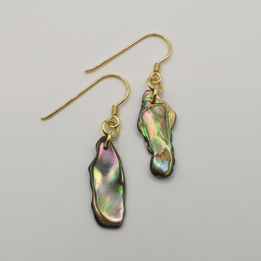 Salty Dreamers' Earrings | Paua Shell Rangi feature handmade, irregularly shaped iridescent pāua shell pendants and gold-plated silver hooks, beautifully displayed on a plain white background.
