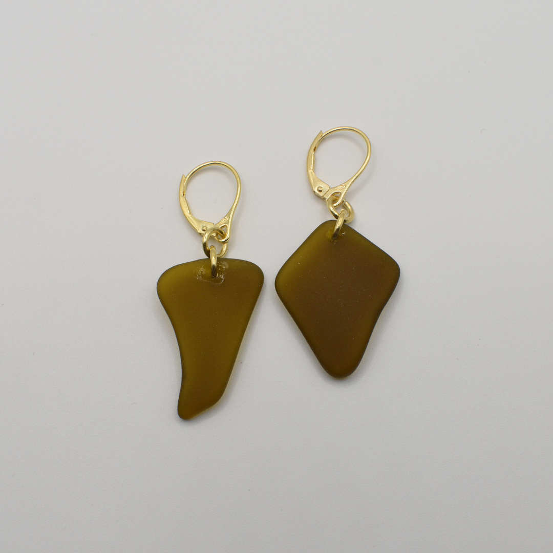 Salty Dreamers’ Earrings | Seaglass Brownie: Handmade gold leverback earrings featuring irregular, translucent brown glass pendants, displayed on a plain white background.