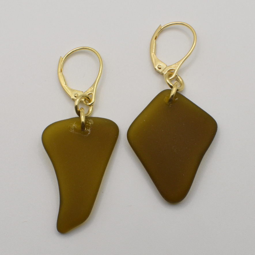 The Seaglass Brownie earrings by Salty Dreamers are handmade with irregular brown glass pieces, each set on a gold lever-back hook, shown against a plain white background.