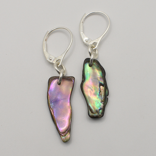 Salty Dreamers’ Earrings | Paua Shell Hine feature handmade, irregular iridescent paua shell pieces with silver hooks, displayed on a light gray background.