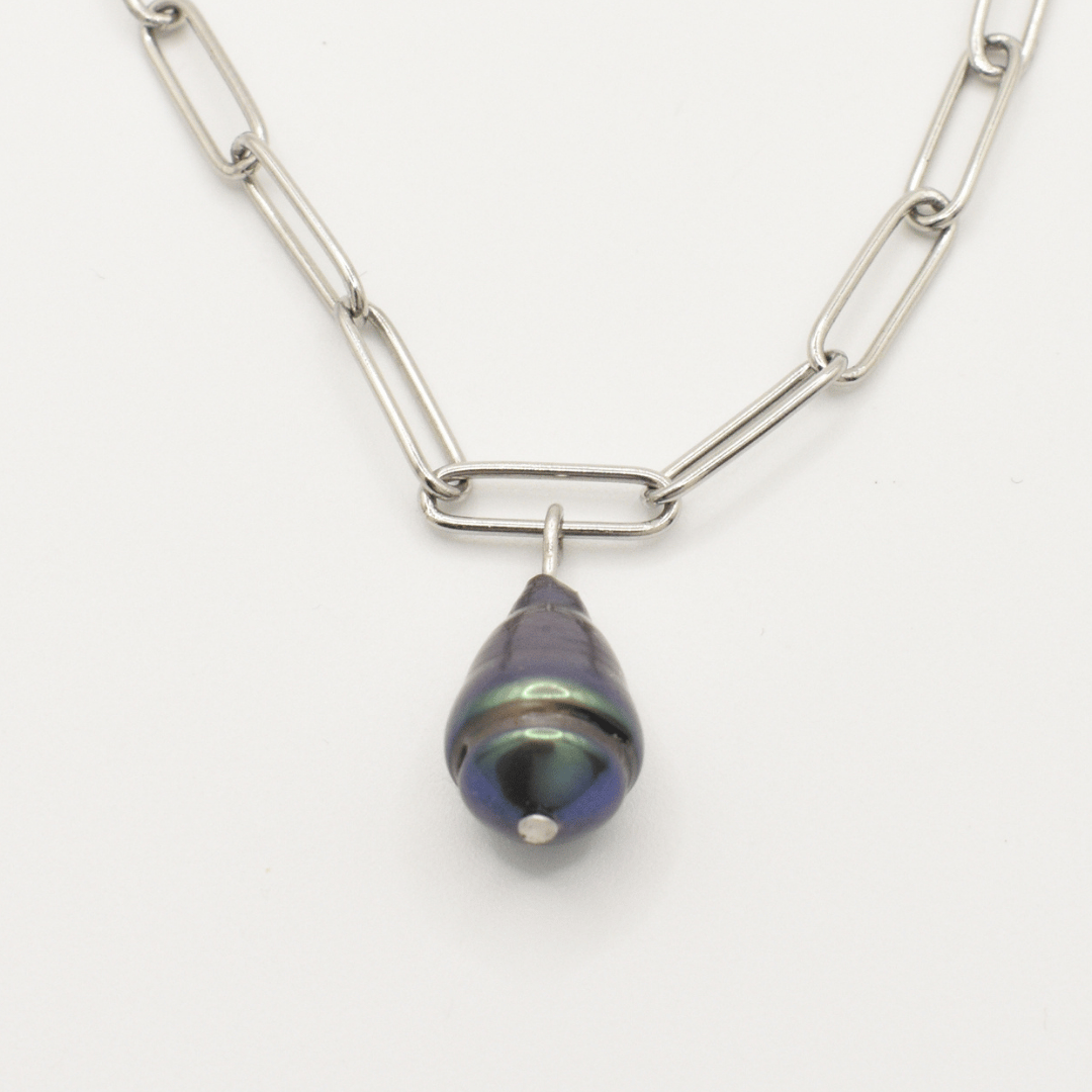 The Salty Dreamers Necklace | Beach Drop Pearl features a silver elongated link chain with a single dark iridescent freshwater pearl pendant, capturing an ocean-inspired look against a plain white background.