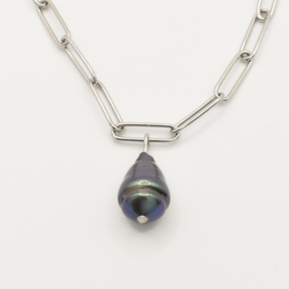 The Salty Dreamers Necklace | Beach Drop Pearl features a silver elongated link chain with a single dark iridescent freshwater pearl pendant, capturing an ocean-inspired look against a plain white background.