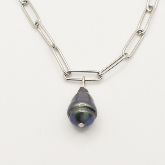 The Salty Dreamers Necklace | Beach Drop Pearl features a silver elongated link chain with a single dark iridescent freshwater pearl pendant, capturing an ocean-inspired look against a plain white background.