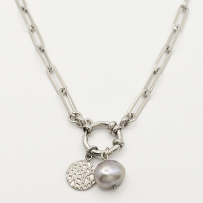 The Salty Dreamers "A Cute Couple Pearl" necklace features a silver chain with a round link centerpiece, a textured circular charm, and an irregular grey freshwater pearl pendant.