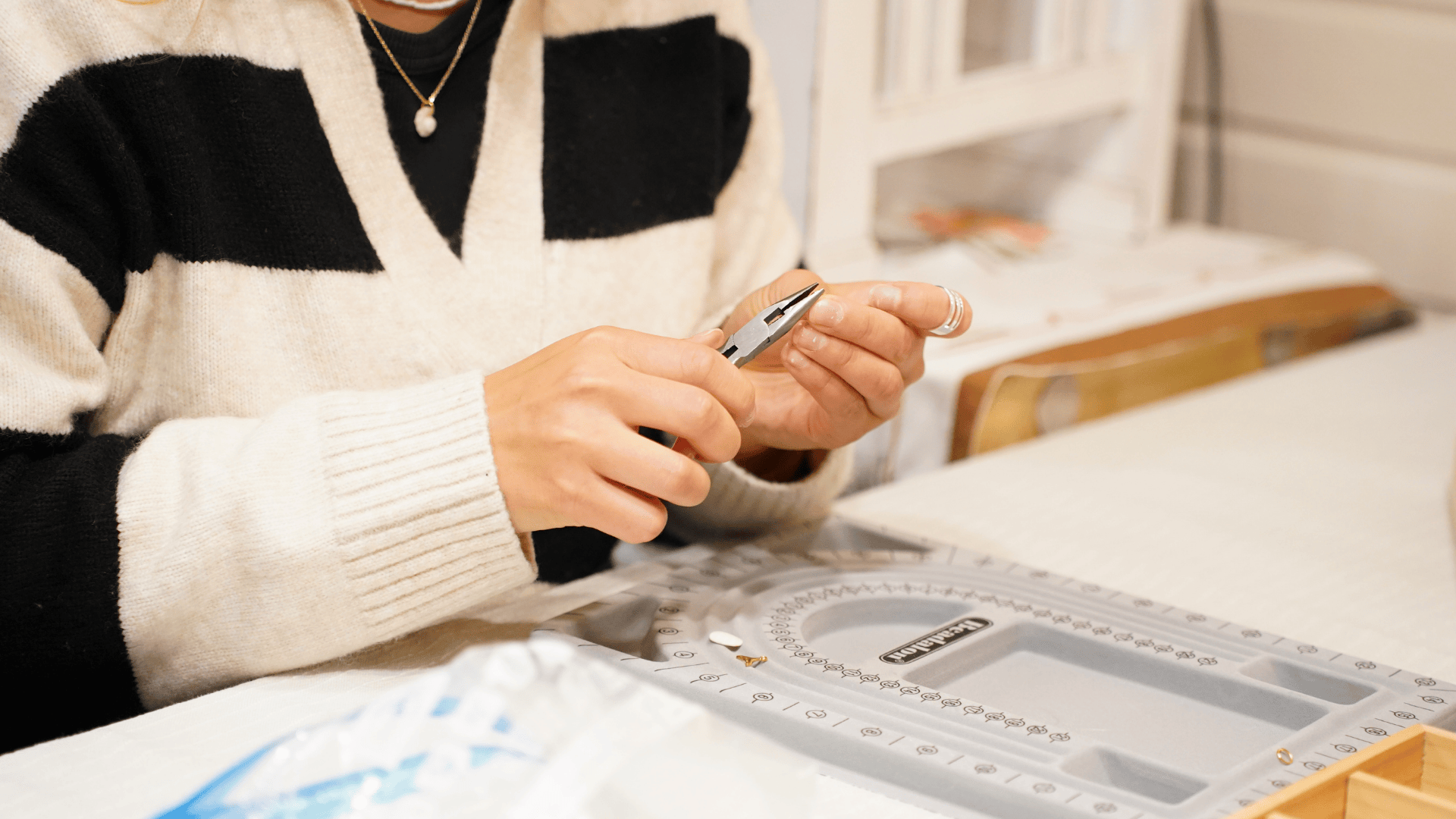 Person using tool to make jewellery with