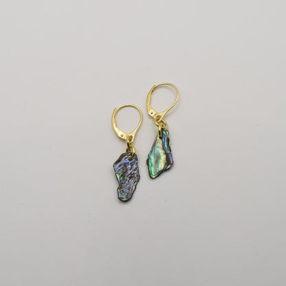 Salty Dreamers' Paua Shell Moana Earrings are handmade gold leverbacks featuring irregular iridescent abalone shell pendants, shown on a plain white background.