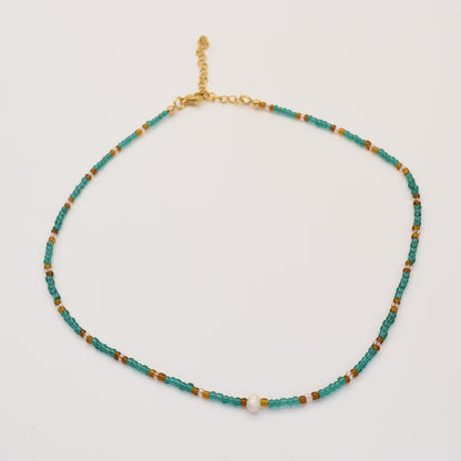 The Necklace | Fresh Beads Blue by Salty Dreamers is a handmade piece featuring turquoise, brown, and gold beads with a central freshwater pearl and an adjustable gold chain clasp, displayed on a white background.