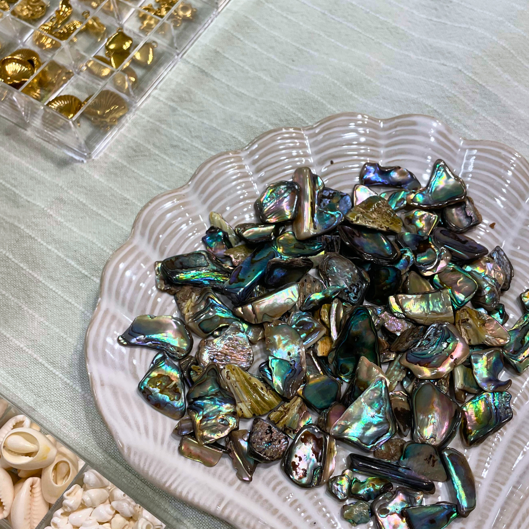 Iridescent paua shell pieces on a textured surface material that is used at the best workshop in Kiel