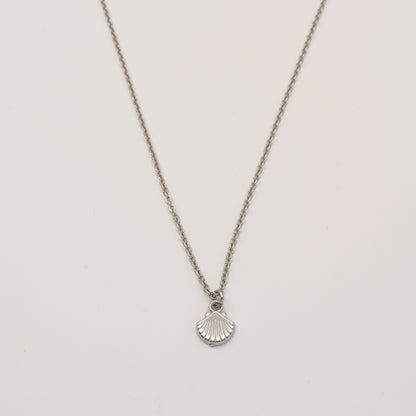 stainless steel necklace with a shell pendant on a light gray background