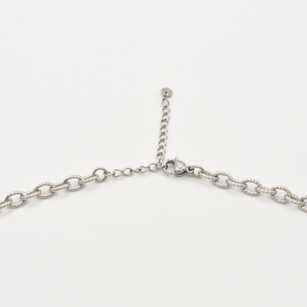 A close-up of the Salty Dreamers Necklace | Paua Shell Hau, a handmade stainless steel piece with lobster clasp and adjustable extension chain, shown on a white background.