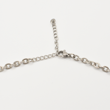 A close-up of Salty Dreamers' "Necklace | A Beach Pearl," a silver chain with lobster clasp and adjustable extension, is shown against a plain white background.