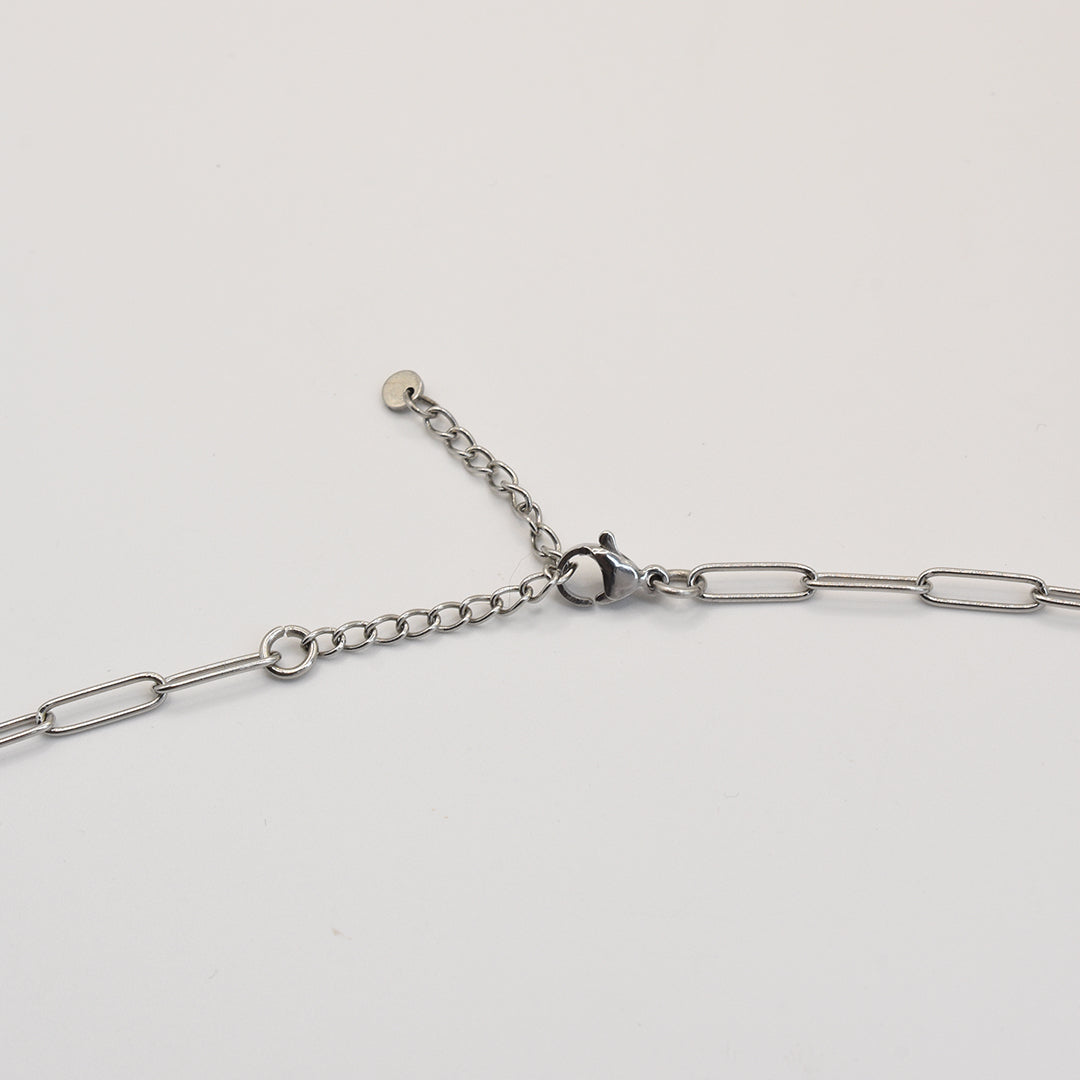 Silver chain necklace on a light white background