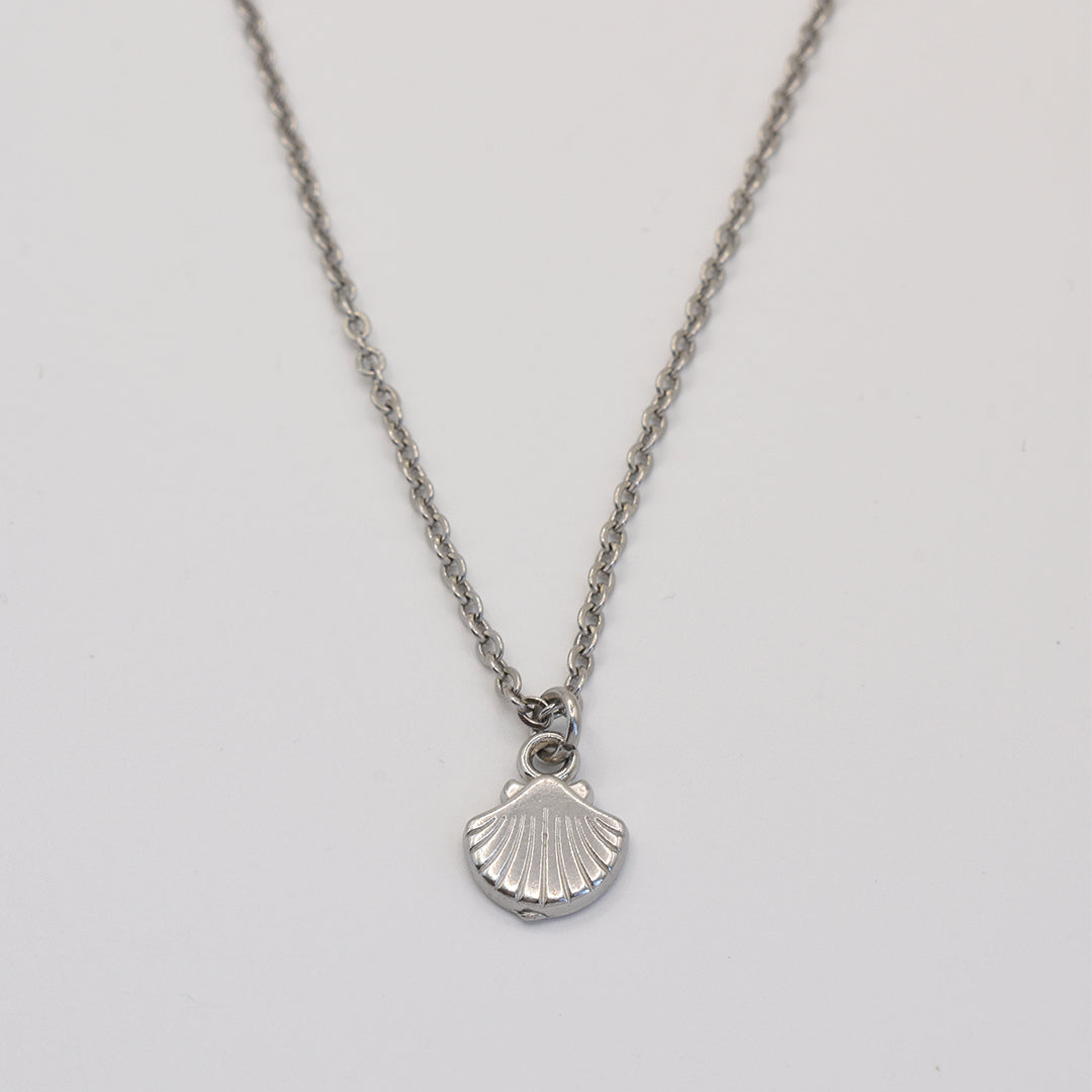 stainless-steel silver necklace with a shell pendant on a light gray background