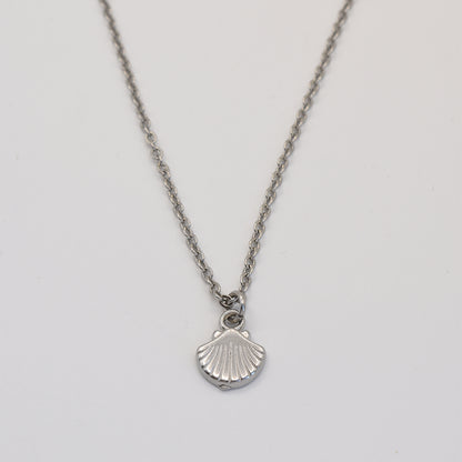 stainless-steel silver necklace with a shell pendant on a light gray background