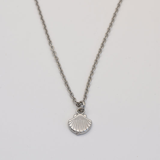 stainless-steel silver necklace with a shell pendant on a light gray background